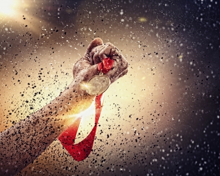 Hand held medal against a stormy skyの写真素材