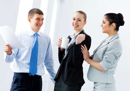 Image of three young businesspeople laughing joyfullyの写真素材