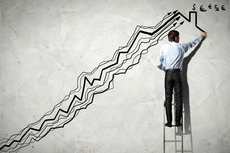 Back view image of businessman drawing graphics on wallの写真素材