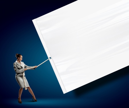 Image of businesswoman pulling blank banner  Place for textの写真素材