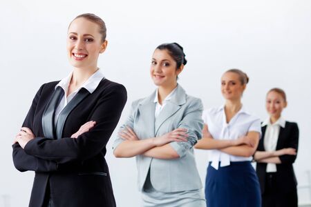 Image of four pretty young businesswomen standing in rowの写真素材