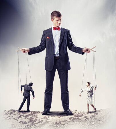 Image of young businessman puppeteer  Leadership conceptの写真素材