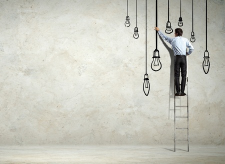 Back view image of businessman drawing graphics on wallの写真素材