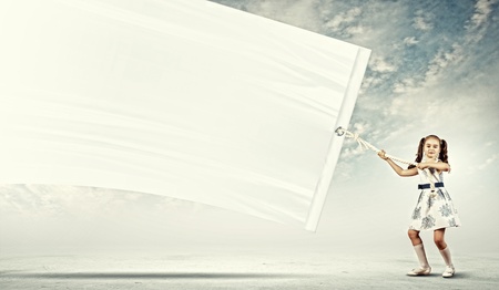 Little pretty girl pulling blank banner  Place for textの写真素材