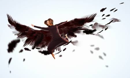 Woman floating in a dance on dark wings  Collage の写真素材