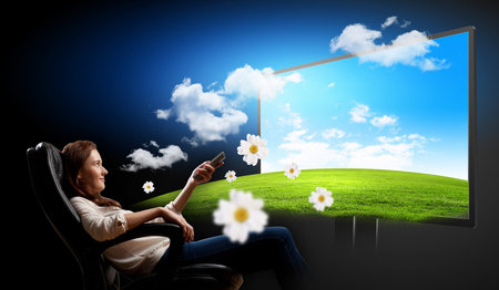 Image of young woman in armchair watching 3d tv