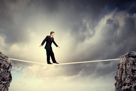 Image of pretty businessman balancing on ropeの写真素材