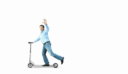 Image of young businessman in black suit riding scooterの写真素材