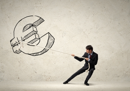 Image of young businessman pulling euro sign rope withの写真素材