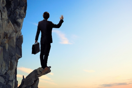 Image of young businessman standing on top of hillの写真素材