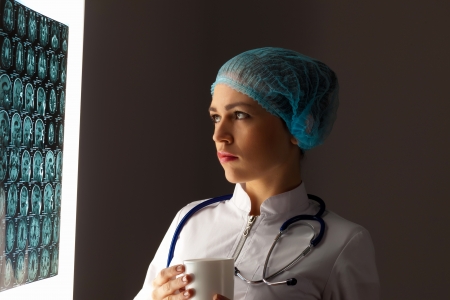 Image of attractive woman doctor looking at x-ray resultsの写真素材
