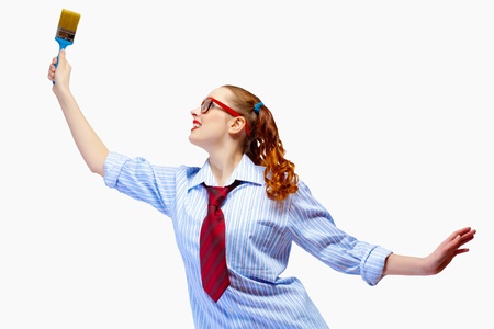 Image of funny teenager girl holding paintbrushの写真素材