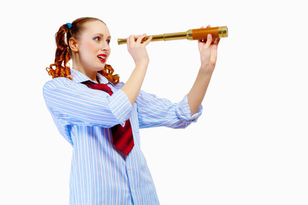 Young pretty woman in red glasses looking in telescope
