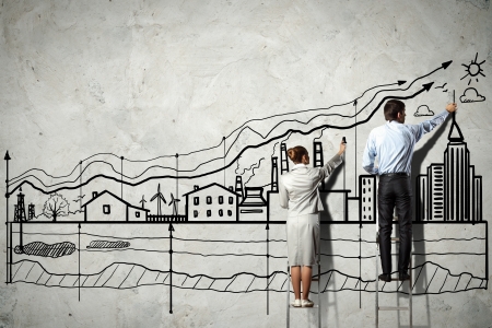 Back view image of businessman drawing graphics on wallの写真素材