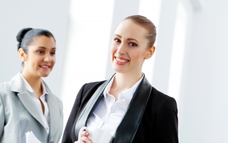 Image of two young pretty businesswomen smilingの写真素材