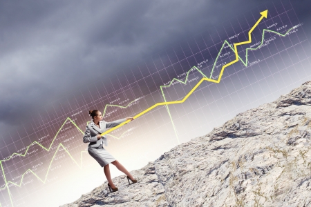 Image of businesswoman pulling graph of diagramの写真素材