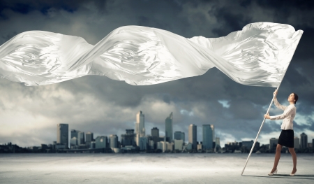 Image of attractive businesswoman holding white flag  Place for textの写真素材