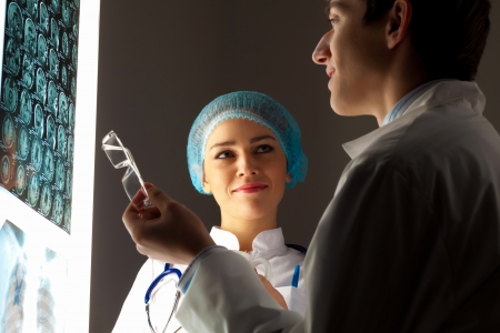 Image of two young two doctors discussing x-ray resultsの写真素材