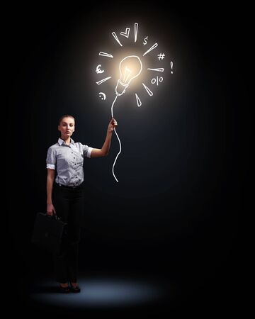 Image of attractive businesswoman against dark backgroundの写真素材