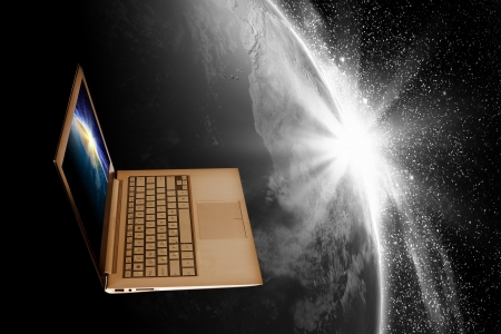 Notebook with our planet earth against black background with globeの写真素材