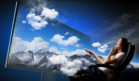 Image of young woman in armchair watching 3d tv