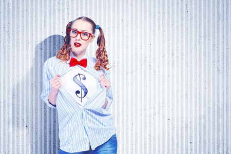 Young woman acting like super hero with dollar sign on chestの写真素材