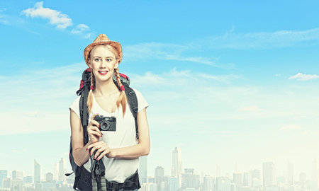 Image of young pretty woman tourist with photo camera