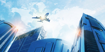 Plane flying above skyscrapers  Business travel conceptの写真素材