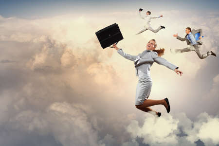 Image of businesspeople jumping high in skyの写真素材