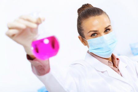 Young female scientist working with liquids in laboratoryの写真素材