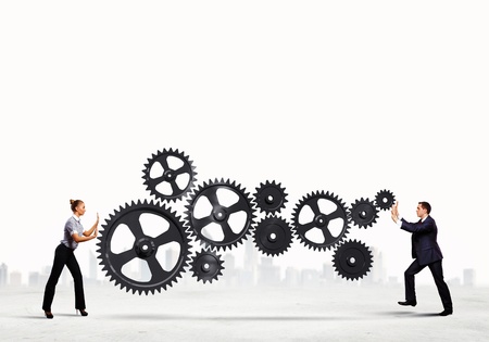 Businessman and businesswoman with cog wheel elements  Organization conceptの写真素材