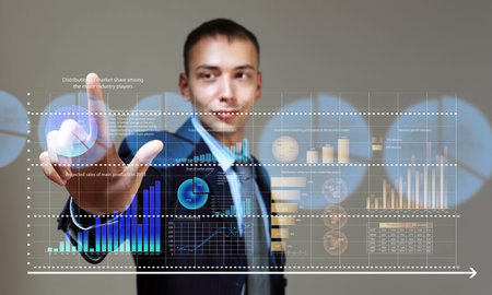 Young businessman touching icon of media screen with diagrams and graphs