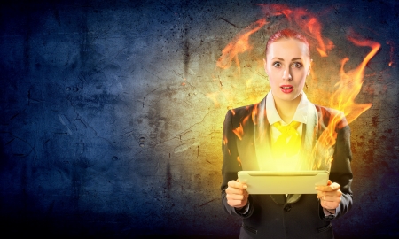 Image of astonished business woman holding a tabletの写真素材