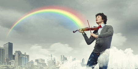 Image of young handsome man playing violin