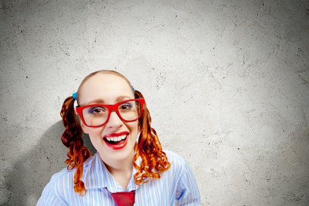 Funny looking red-hair woman with glasses staring at camera