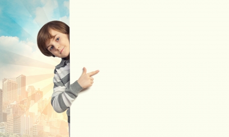 Little boy holding a blank white billboardの写真素材