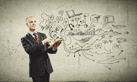 Image of young businessman holding ipad against sketch backgroundの写真素材