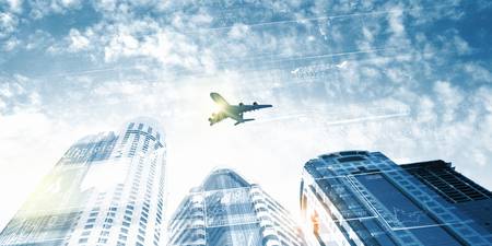Plane flying above skyscrapers  Business travel conceptの写真素材