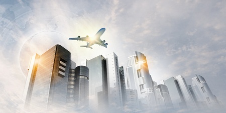 Plane flying above skyscrapers  Business travel conceptの写真素材