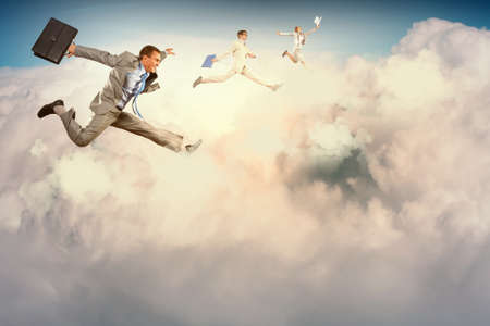 Image of businesspeople jumping high in skyの写真素材