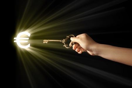Close-up of human hand holding key  Money conceptの写真素材