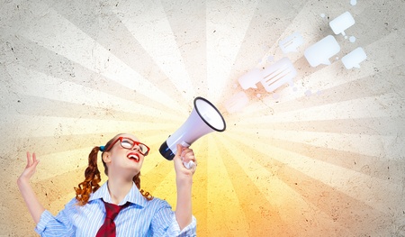 Funny looking woman speaking with a megaphoneの写真素材