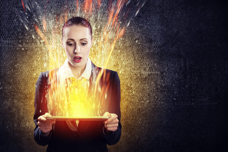 Image of astonished business woman holding tablet pc