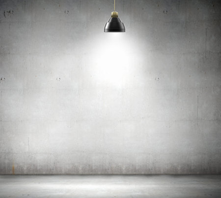 Stone blank wall illuminated with hanging above lamp  Place for textの写真素材
