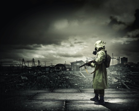 Man in gas mask and camouflage holding gun  Disaster conceptの写真素材