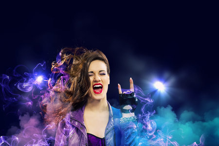 Young attractive rock girl playing the electric guitarの写真素材