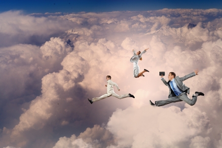 Image of businesspeople jumping high in skyの写真素材