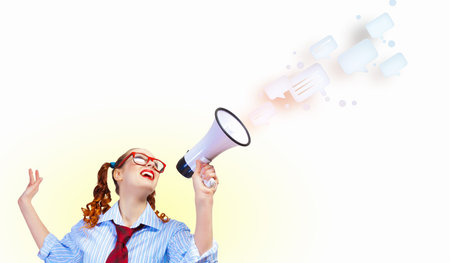 Funny looking woman speaking with a megaphoneの写真素材