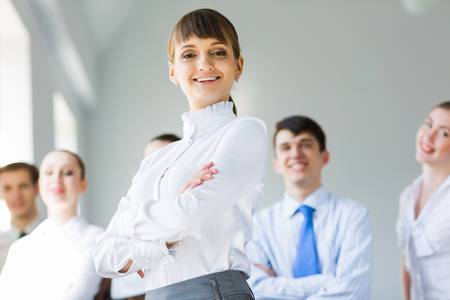 Young business people standing with arms crossed on chestの写真素材