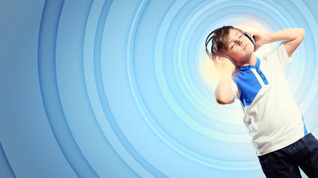 Little cute boy in headphones with eyes closed enjoying musicの写真素材